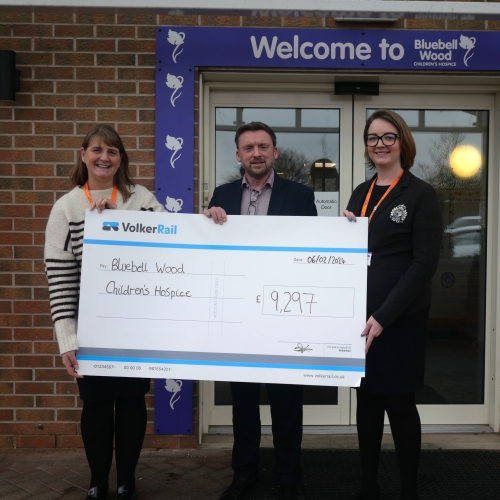 Handing over a large cheque to Bluebell Wood Children's hospice 