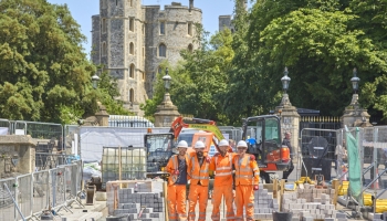 People in orange high vis working on the road