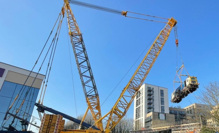 Beaver tamper being lifted by crane on to track