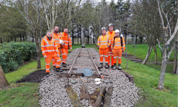 group of men after completing volunteering project to restore a piece of track from the Thai Burma Railway Memorial
