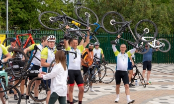 cycling cheering with bikes in the air