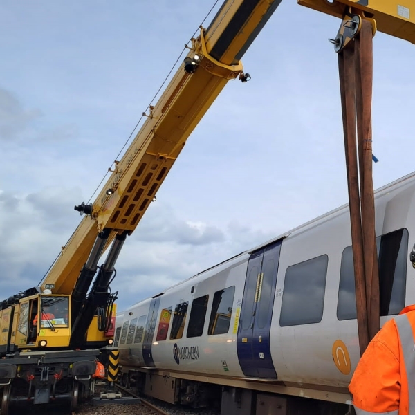A 1200 Kirow crane rerailing a derailed passenger train